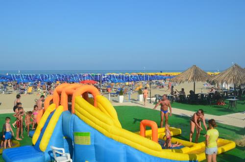 a group of people at the beach with an inflatable slide at Residence Riviera in Alba Adriatica