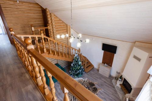 a christmas tree in a room with a staircase at Bambetli in Tatariv