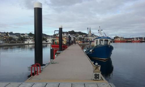 a boat is docked at a dock in the water at Seawinds Bed and Breakfast in Killybegs