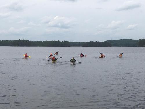 a group of people kayaking on a lake at Jurtta Linkkumylly in Mäntyharju