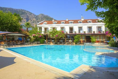 a large swimming pool in front of a building at Göcek Lykia Resort Premium Concept Hotel in Göcek