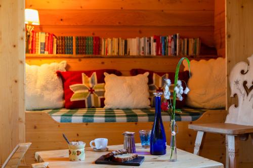 a room with a bed with a table with flowers on it at Hôtel La Ferme du Chozal, Chalet de tradition in Hauteluce