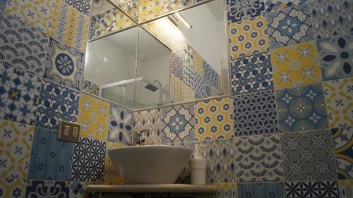 a bathroom with a sink and a mirror at Domo 'e chelu in Orosei
