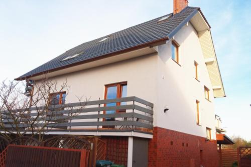 a white house with a black roof at Willa Róż in Międzyzdroje