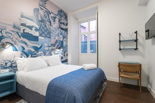 a bedroom with a large bed and a wall mural at Bairro Alto Guesthouse in Lisbon