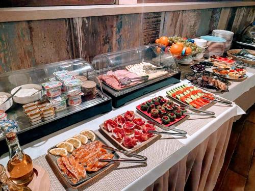 a buffet with many different types of food on a table at Sharden Villa Boutique Hotel in Tbilisi City