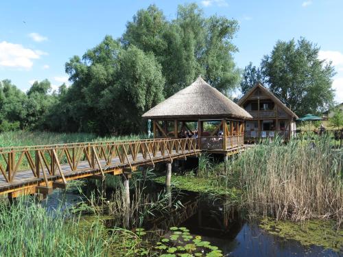 eine Brücke über einen Teich mit einem Pavillon in der Unterkunft House of LoVra in Kneževi Vinogradi