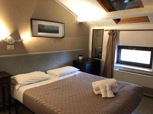 Postel nebo postele na pokoji v ubytování Hotel Casale dei Massimi