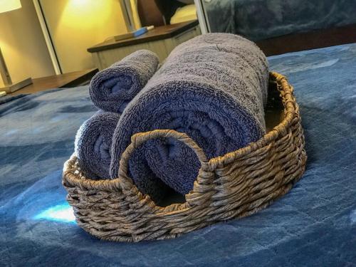a towel sitting on top of a bed at Private Jacuzzi Oasis with Mountain Views and FREE Parking in Ponce