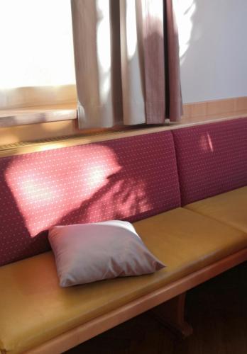 a bench with a pillow on a train at Hotel Mauernböck in Rottenbach