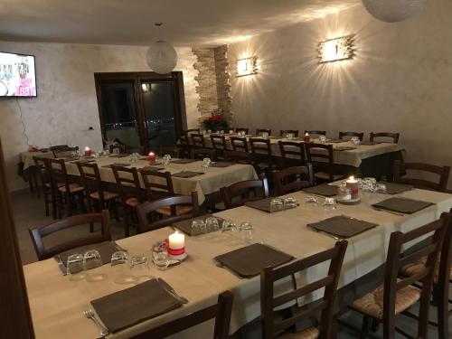 a dining room with tables and chairs with candles at Agriturismo Terra Verde in Rotonda