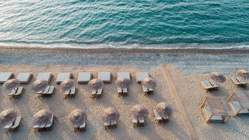 an overhead view of a beach with chairs and umbrellas at Mitsis Ramira in Kos Town