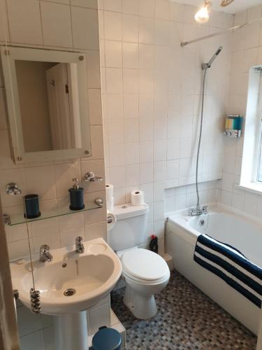 a bathroom with a toilet and a sink and a tub at South Shield's Hidden Gem Emerald Apartment sleeps 6 Guests in South Shields