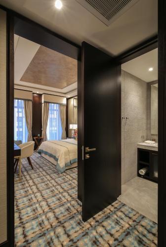 a hotel room with a bed and a bathroom at SOHO boutique hotel in Dnipro