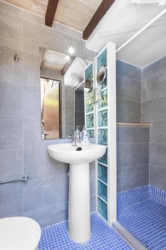 a bathroom with a white sink and a shower at Can Darder in Sóller