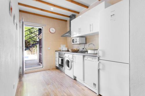 a kitchen with a refrigerator and a washer and dryer at Can Darder in Sóller