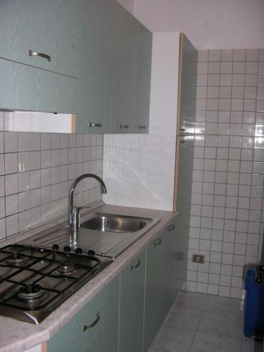 a kitchen with a sink and a stove in it at Villeta Laura in Baia verde in Il Monte
