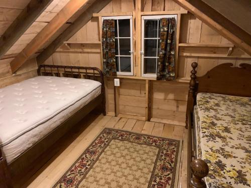 an attic room with a bed and a window at Blue Lodge in Hesston