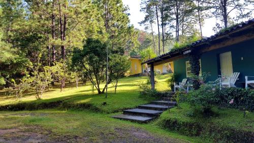 a house with stairs leading to a yard at Cabañas Bosque llano de la Virgen in Intibucá