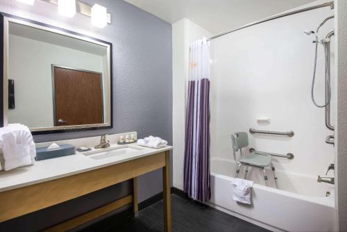 a bathroom with a sink and a tub and a shower at La Quinta by Wyndham Morgantown in Morgantown