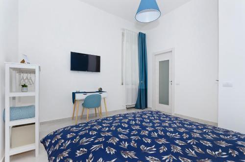 a bedroom with a blue bed and a desk at Blunotte Torino - Piazza Castello in Turin