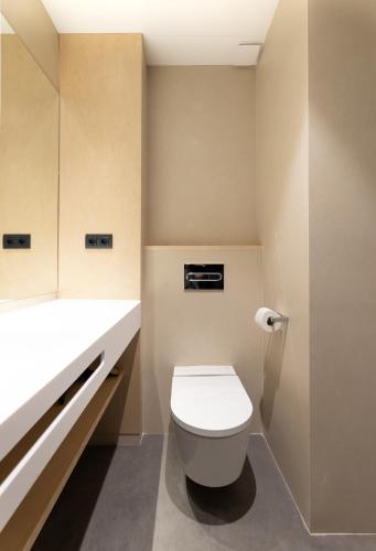 a bathroom with a white toilet and a sink at Hotel Raval House in Barcelona