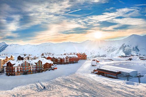 a resort in the snow with mountains in the background at New Gudauri, Red Co, Loft 1 in Gudauri