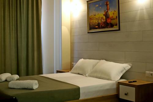 a bedroom with a bed and a painting on the wall at New Gudauri, Red Co, Loft 1 in Gudauri
