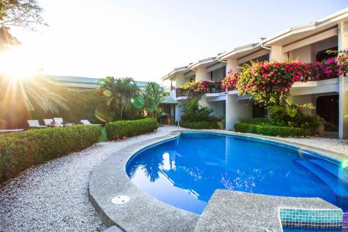 a large blue swimming pool next to a building at Hotel Giada in Sámara