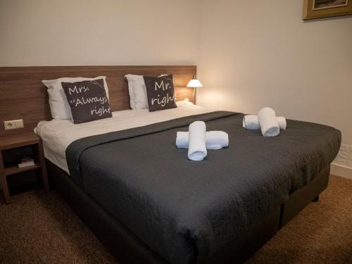 a bedroom with a large bed with two pillows at Hotel Hague Center in The Hague