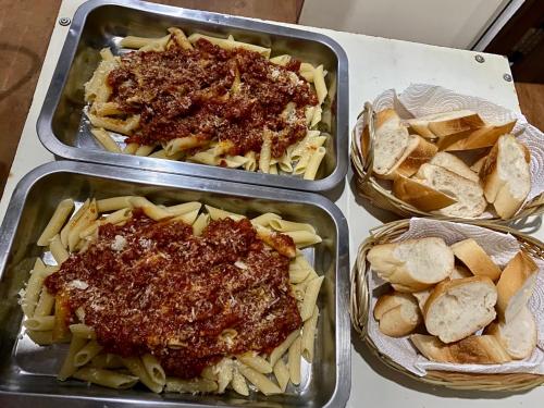 three trays of food with meat sauce and pasta at Sean Sabai Home e Ristobar in Taling Ngam Beach