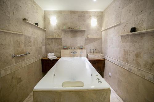 a bathroom with a large tub and a sink at Hotel Tower Inn & Suites in San Rafael