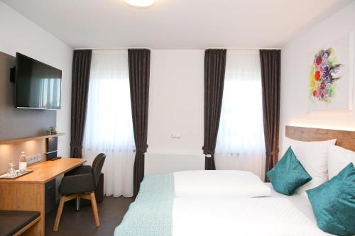 a hotel room with a bed and a desk at Gasthof Hotel Adler Inneringen in Inneringen-Hettingen