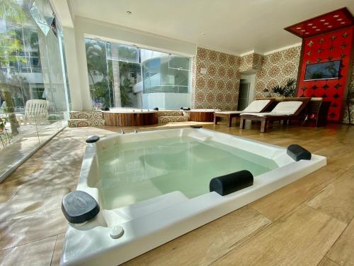 a large white tub in a living room at Scaini Palace Hotel in Arroio do Silva