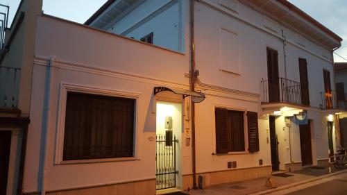 a white building with a window on a street at Orchidea Rooms & Suites in Civitanova Marche