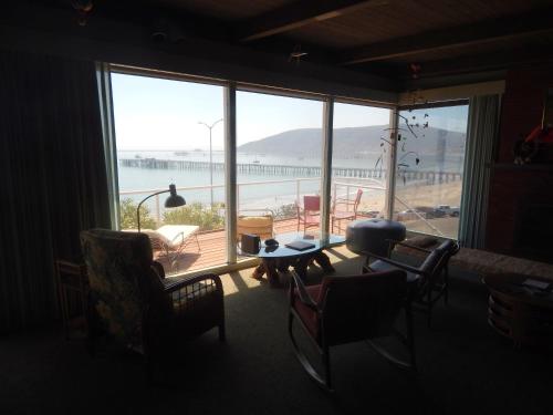 a living room with a large window with a view of the ocean at 196 Front Street in Avila Beach