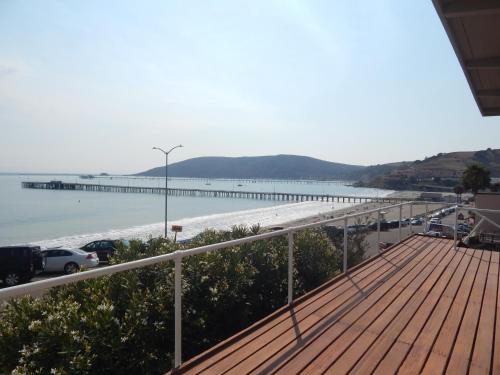 a balcony with a view of the beach and a pier at 196 Front Street in Avila Beach