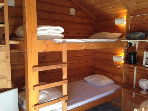 a bunk bed in a log cabin at Yxningens Holiday Homes, Cottages and Camping in Gusum