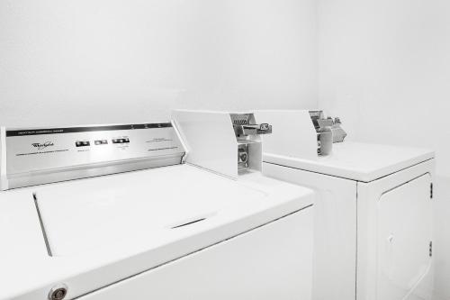 a bathroom with two sinks and two faucets at FairBridge Inn and Suites Sandpoint in Ponderay