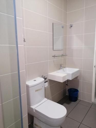 a bathroom with a toilet and a sink at A&D Home-stay @Kota Warisan, Sepang (KLIA 15 min) in Sepang