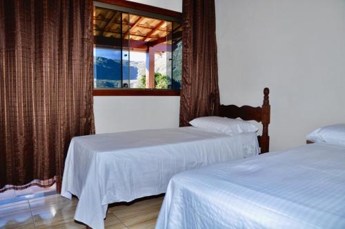 Un pat sau paturi într-o cameră la Vila Dos Sonhos Lapinha
