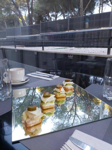 a tray of sandwiches sitting on a table at H La Cabaña in Pozuelo de Alarcón