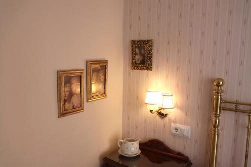 a room with a lamp and pictures on the wall at Casa l'avia in Ribes de Freser