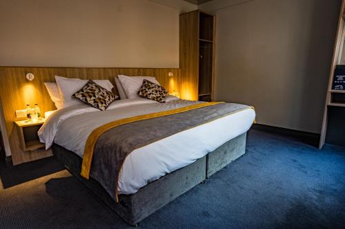 a bedroom with a large bed in a room at The Old Quarter Townhouse in Limerick