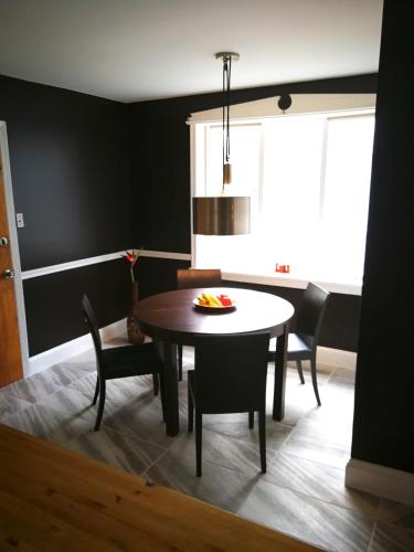 a dining room with a table and chairs at Rainbow House and small garden in Princeton