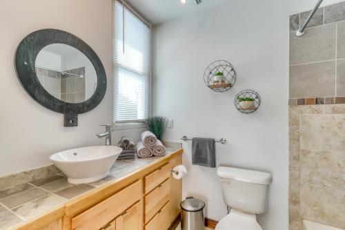 a bathroom with a sink and a toilet and a mirror at Contemporary Maine Retreat in Bethel