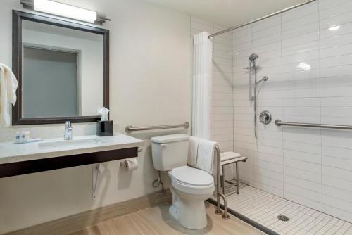 a bathroom with a toilet and a sink and a shower at Comfort Inn & Suites Tigard near Washington Square in Tigard