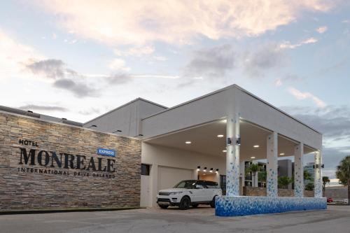 a car dealership with a white car parked in it at Hotel Monreale Express International Drive Orlando in Orlando