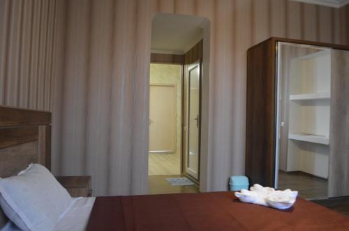 a bedroom with a bed and a large mirror at hill-fort kutaisi in Kutaisi