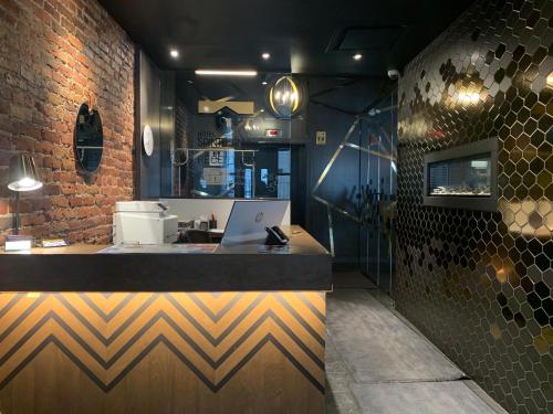 a kitchen with a counter with a laptop on it at Hôtel Sainte-Anne in Quebec City